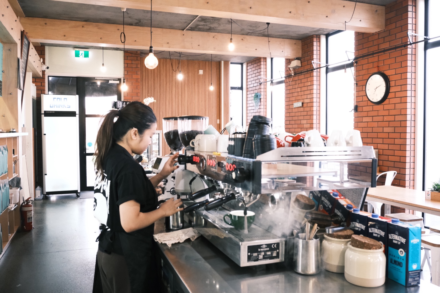 A Coffee Nation barista preparing coffee at the espresso machine