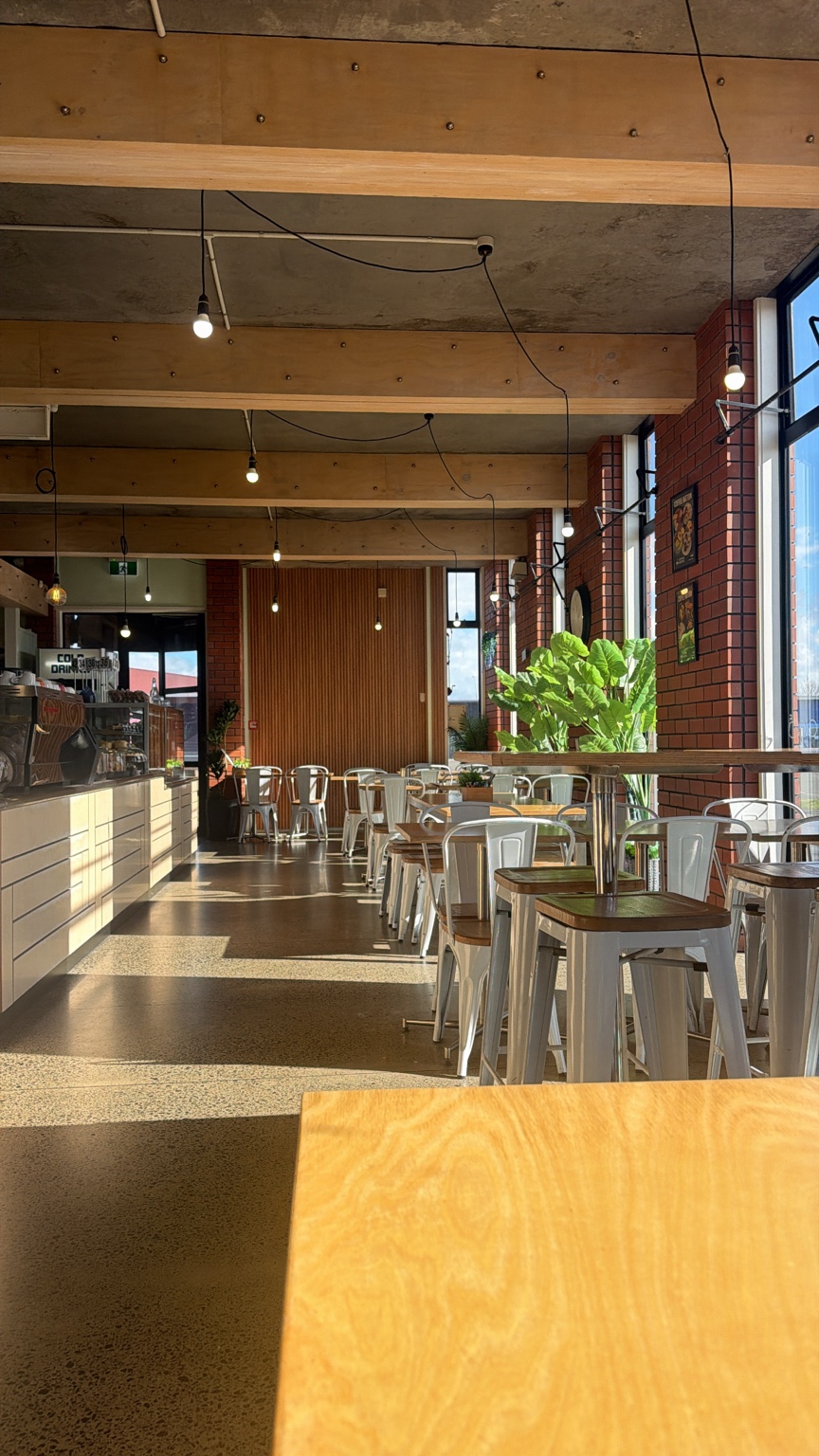 Warm sunlight across the wooden tables and seating at Coffee Nation